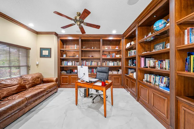 a view of a dining room with furniture and a chandelier
