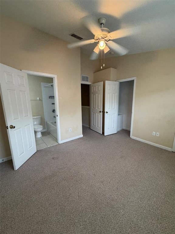 809 Shropshire Loop Sanford, FL 32771 - Photo 16 of 21 an empty room with a ceiling fan and bathroom view