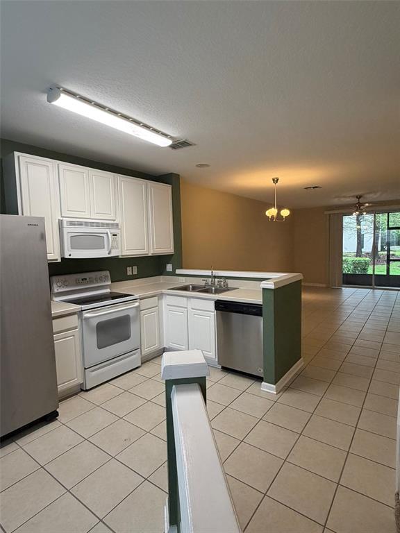 809 Shropshire Loop Sanford, FL 32771 - Photo 2 of 21 a kitchen with a stove sink and cabinets