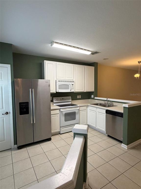 809 Shropshire Loop Sanford, FL 32771 - Photo 3 of 21 a kitchen with granite countertop white cabinets and white appliances
