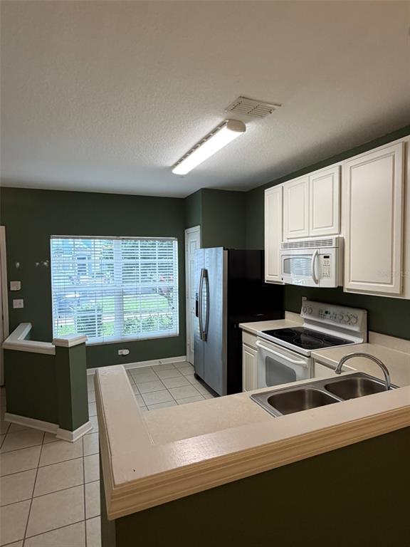 809 Shropshire Loop Sanford, FL 32771 - Photo 4 of 21 a kitchen that has a sink cabinets appliances and a window