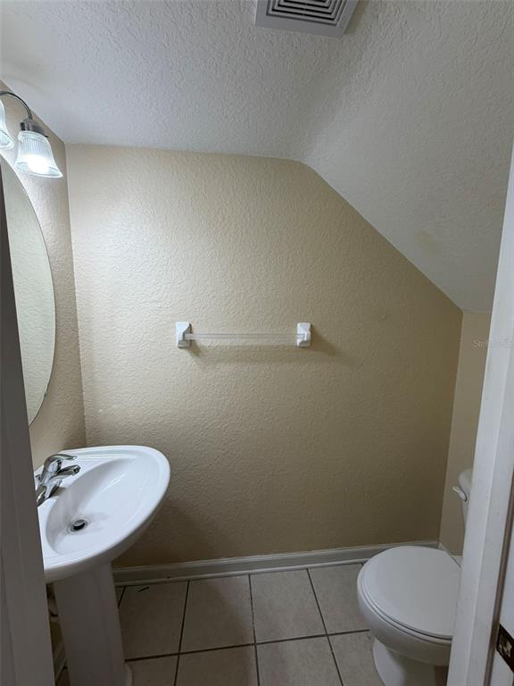 809 Shropshire Loop Sanford, FL 32771 - Photo 7 of 21 a bathroom with a sink a toilet and a mirror