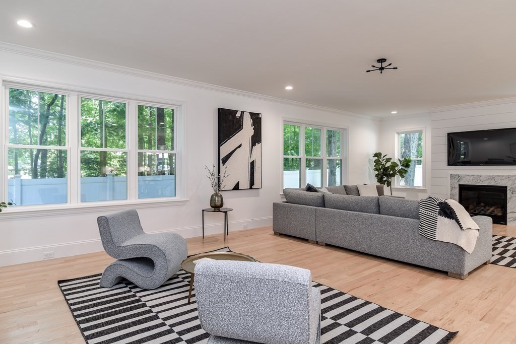 33 Birch Road Natick, MA 01760 - Photo 9 of 35 a living room with furniture a large window and a fireplace