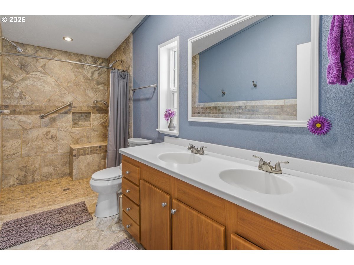 475 East 9th Street Rainier, OR 97048 - Photo 15 of 43 a bathroom with a sink toilet a mirror and shower