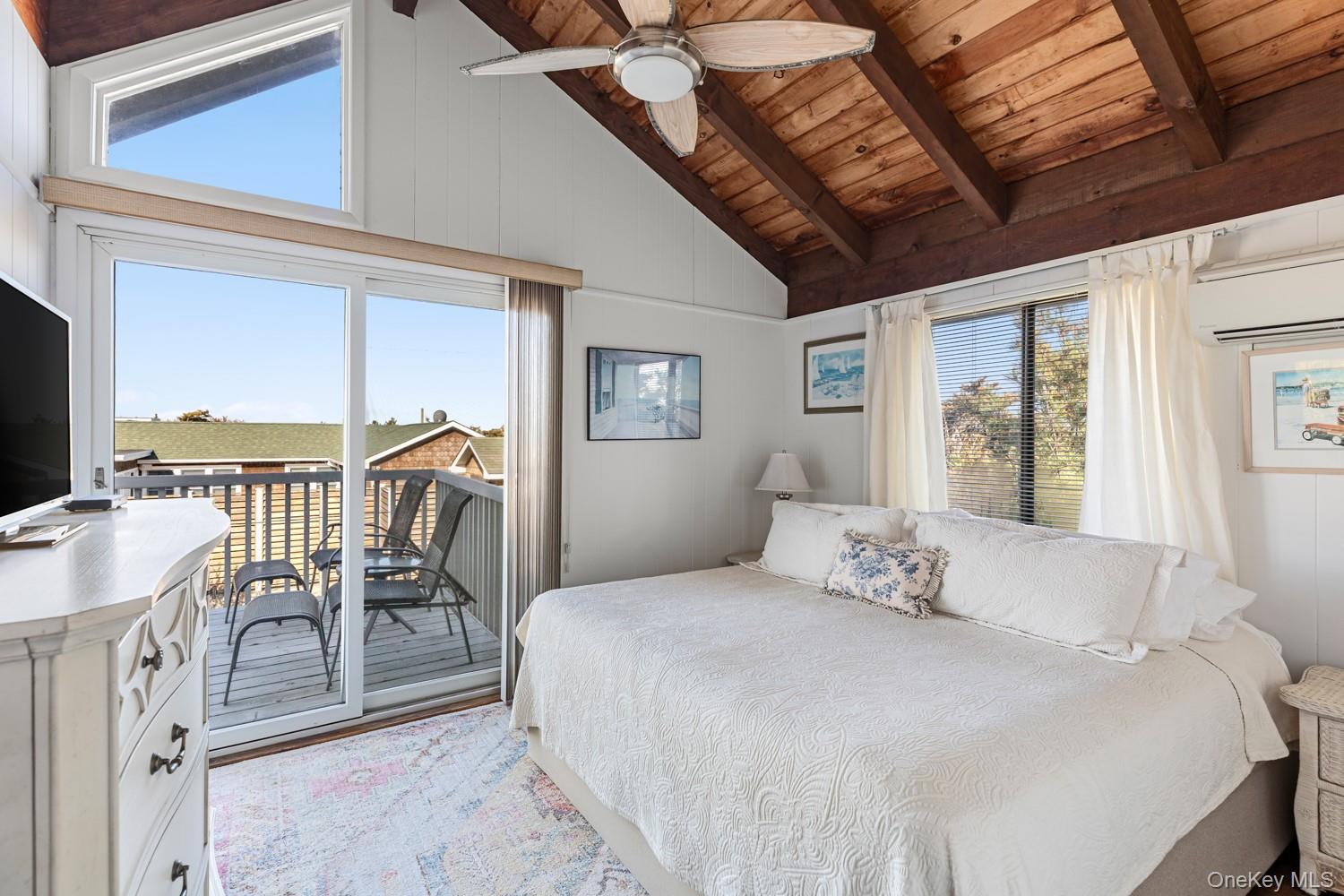 200 Clipper Road Ocean Beach, NY 11706 - Photo 15 of 29 a bedroom with a large bed and a large window