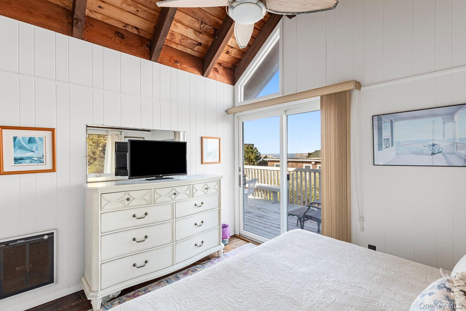 200 Clipper Road Ocean Beach, NY 11706 - Photo 16 of 29 a bedroom with a bed and a flat screen tv