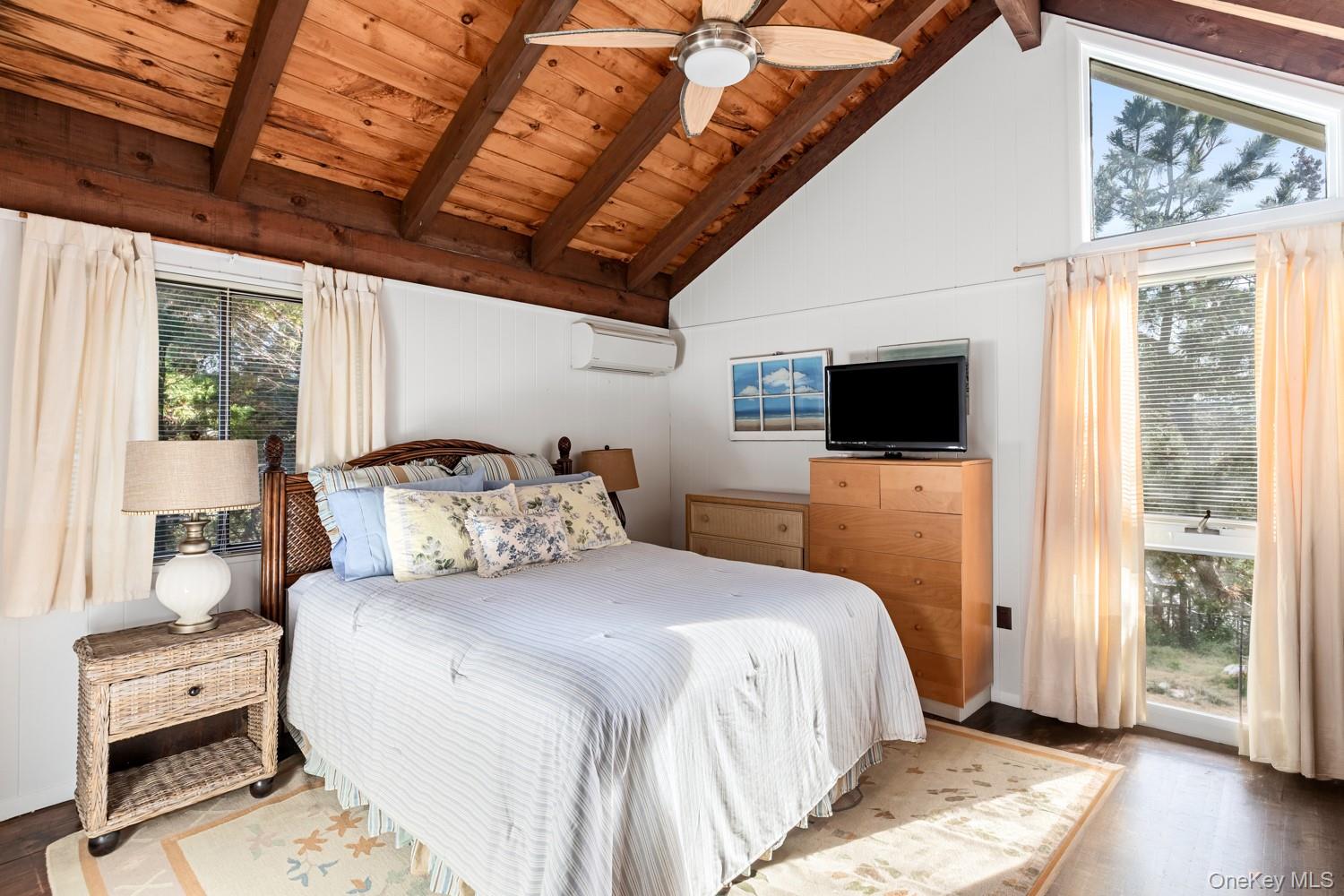 200 Clipper Road Ocean Beach, NY 11706 - Photo 20 of 29 a bedroom with a bed and a flat screen tv