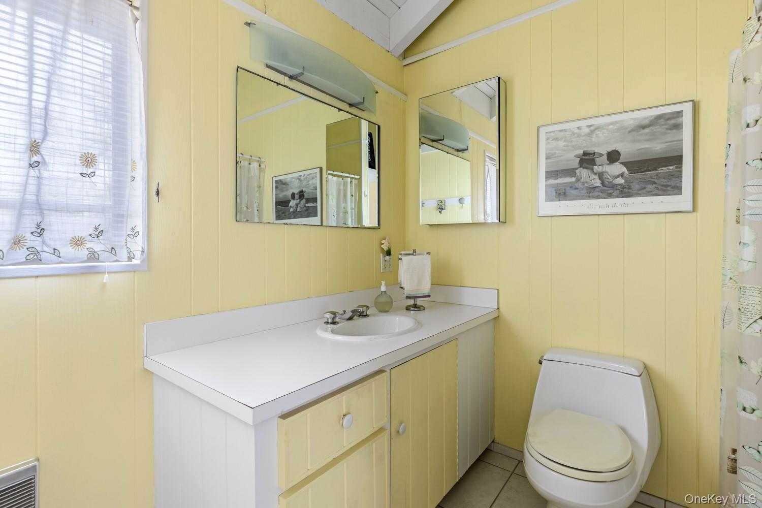 200 Clipper Road Ocean Beach, NY 11706 - Photo 21 of 29 a bathroom with a toilet sink and mirror