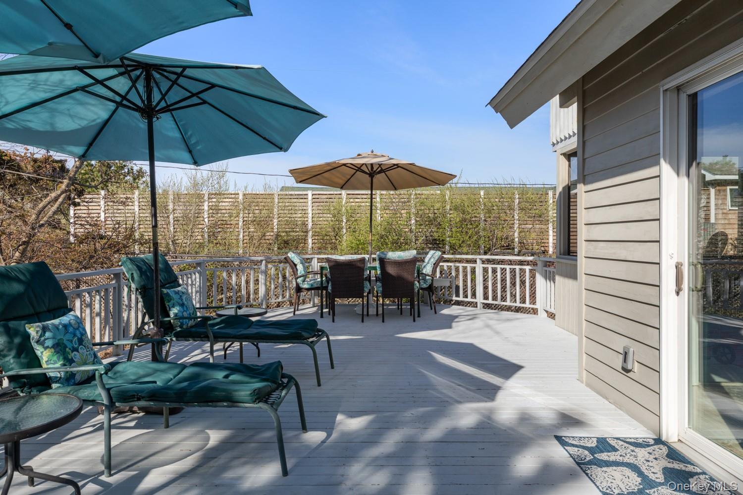 200 Clipper Road Ocean Beach, NY 11706 - Photo 22 of 29 a view of a patio with a table and chairs under an umbrella