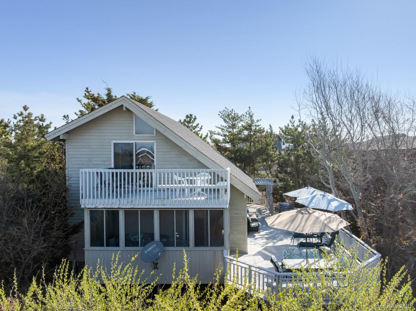 200 Clipper Road Ocean Beach, NY 11706 - Photo 3 of 29 a front view of a house with a garden