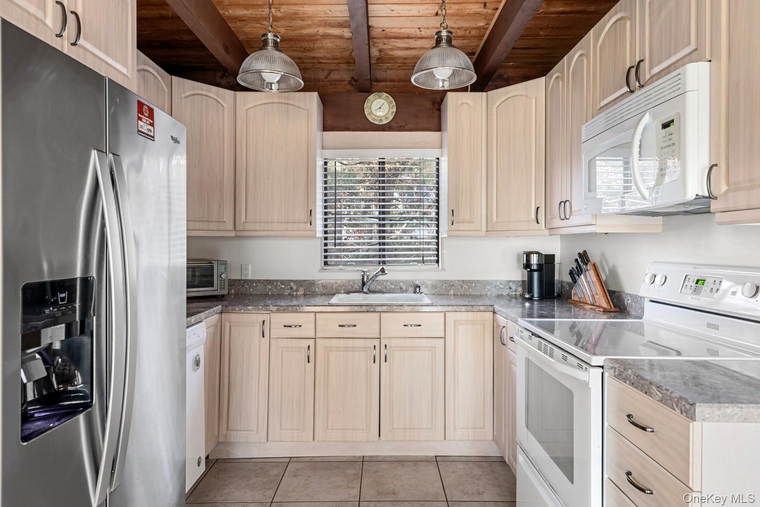 200 Clipper Road Ocean Beach, NY 11706 - Photo 6 of 29 a kitchen with stainless steel appliances granite countertop a sink a stove a refrigerator and cabinets