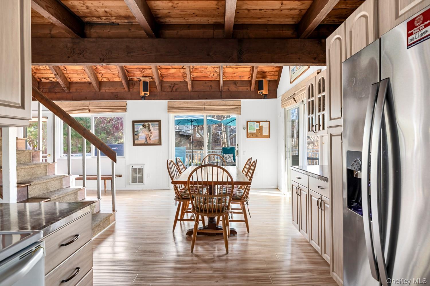 200 Clipper Road Ocean Beach, NY 11706 - Photo 10 of 29 a dining room with furniture a chandelier and wooden floor