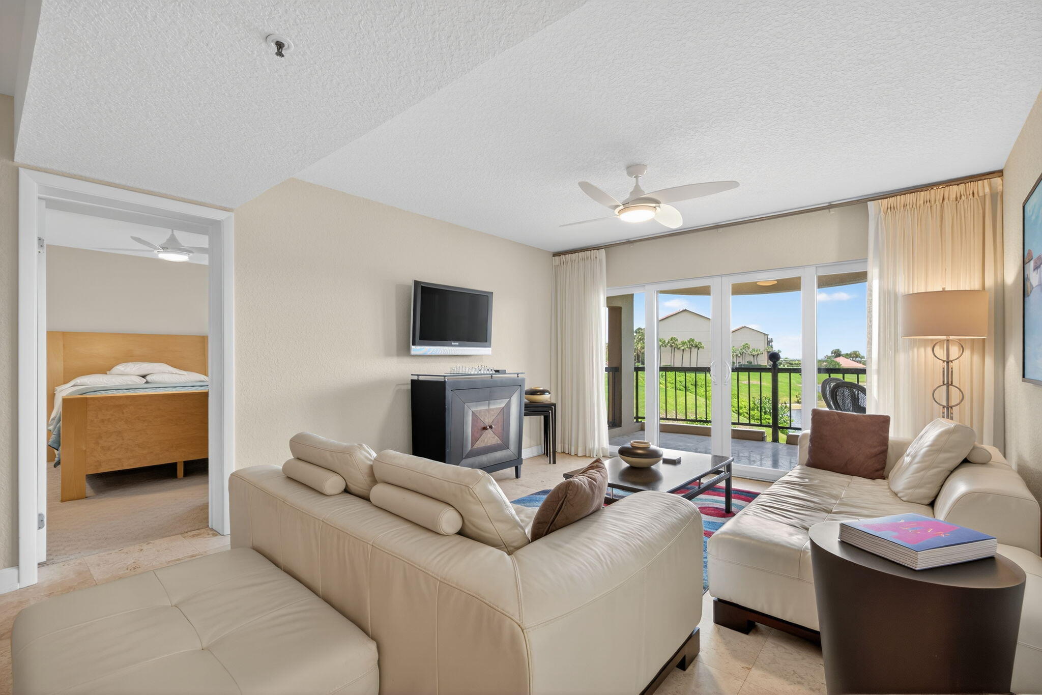 401 Ocean Bluffs Boulevard, Unit 205 Jupiter, FL 33477 - Photo 12 of 42 a living room with furniture and a large window