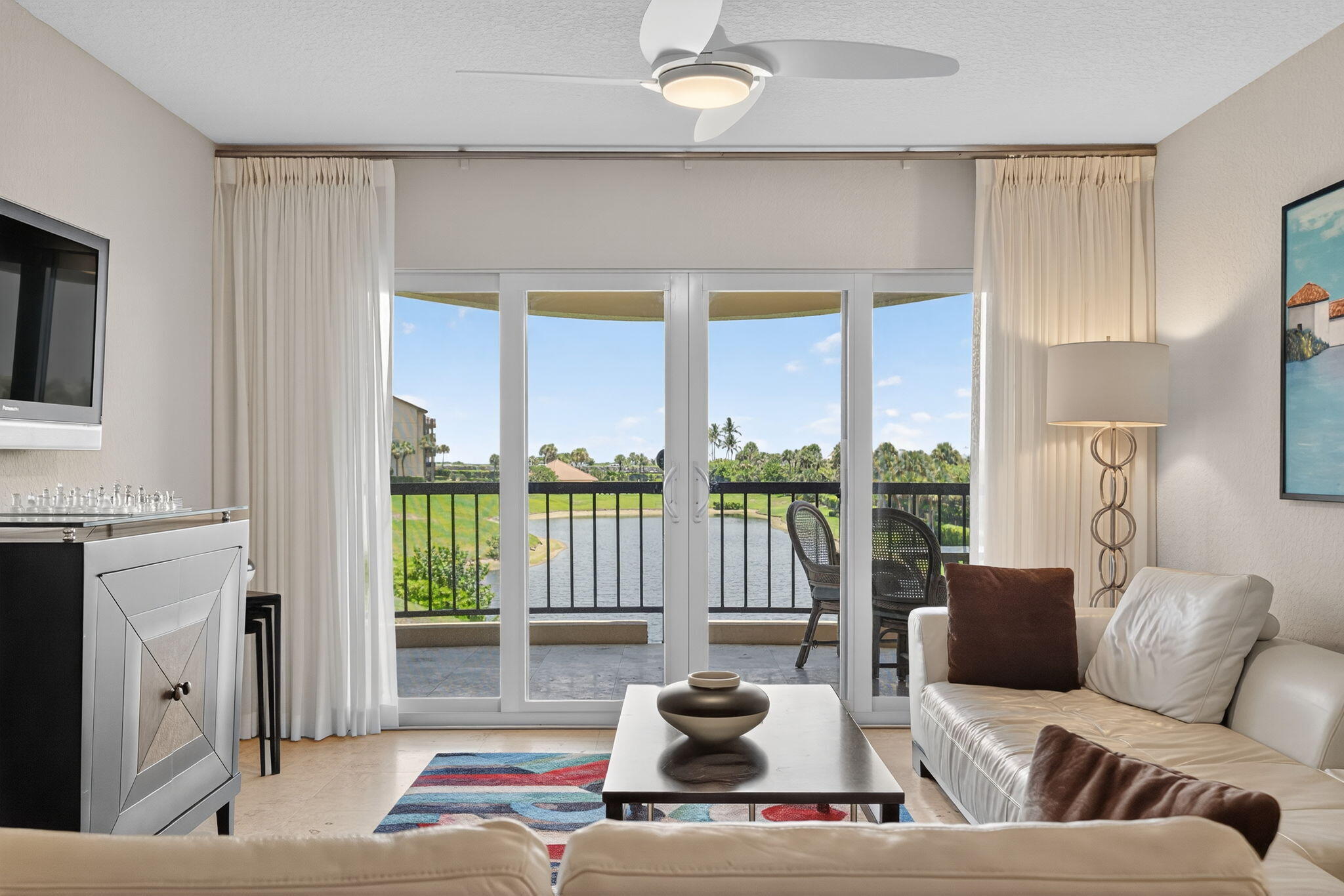 401 Ocean Bluffs Boulevard, Unit 205 Jupiter, FL 33477 - Photo 14 of 42 a living room with furniture and large windows
