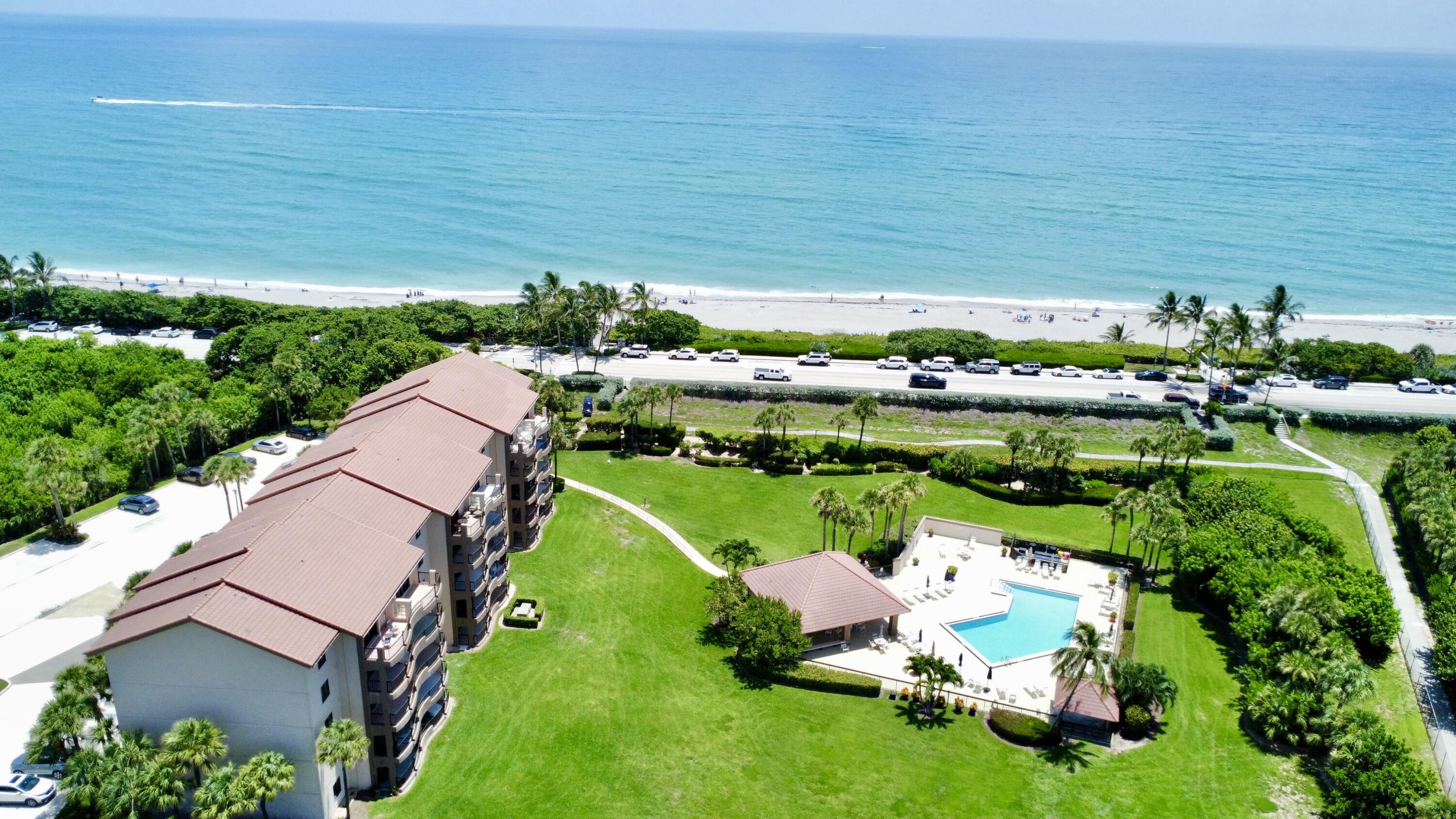 401 Ocean Bluffs Boulevard, Unit 205 Jupiter, FL 33477 - Photo 25 of 42 a view of a golf course with chairs