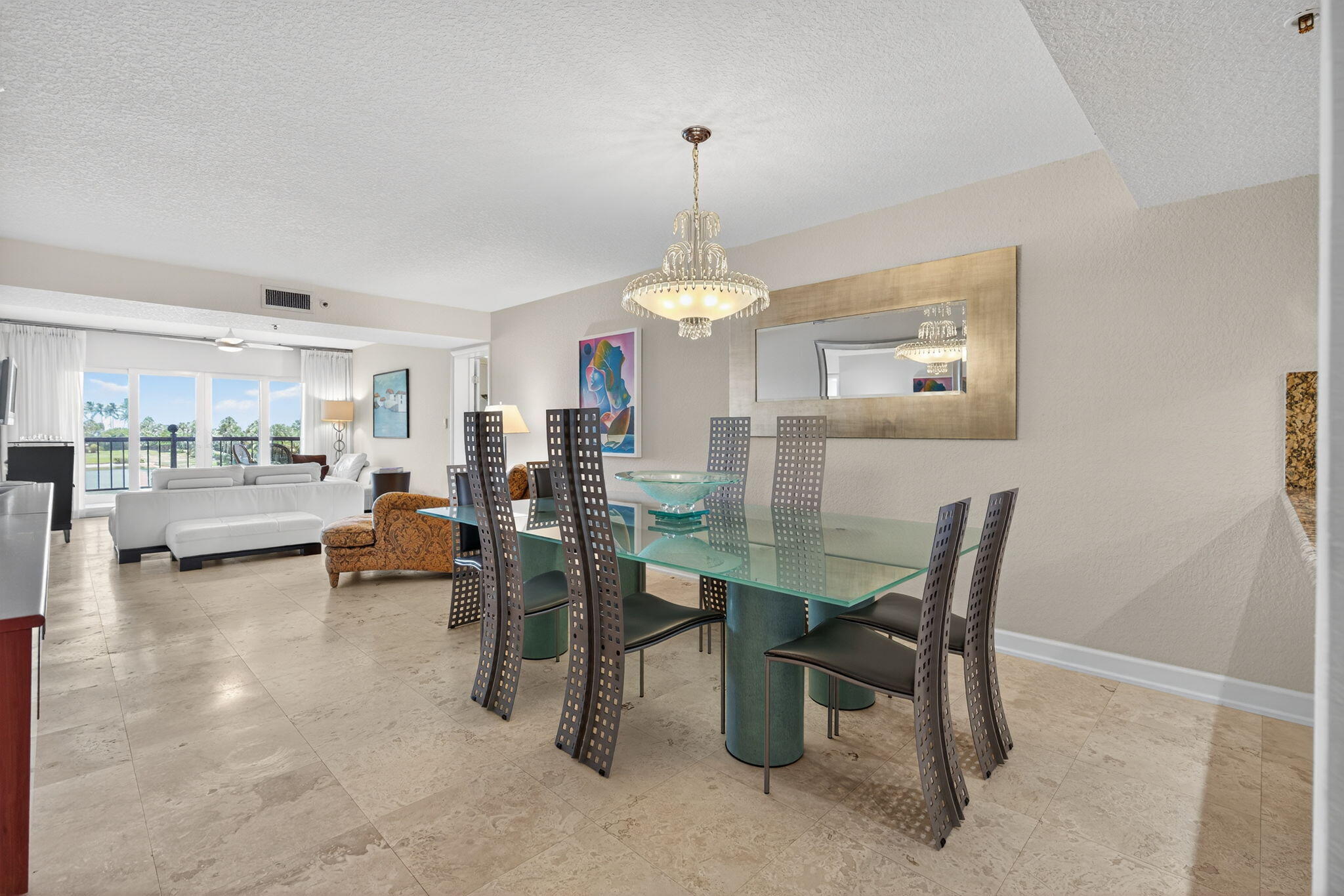 401 Ocean Bluffs Boulevard, Unit 205 Jupiter, FL 33477 - Photo 8 of 42 a view of a dining room with furniture and a chandelier