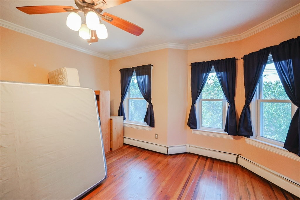 107 Lake Street, Unit B Webster, MA 01570 - Photo 16 of 42 a view of an empty room with wooden floor and a window