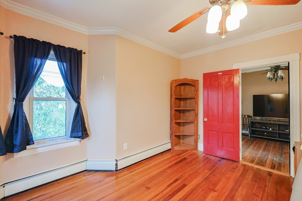 107 Lake Street, Unit B Webster, MA 01570 - Photo 18 of 42 a view of an empty room with a window and wooden floor