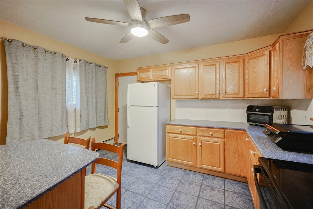 107 Lake Street, Unit B Webster, MA 01570 - Photo 2 of 42 a kitchen with stainless steel appliances granite countertop a refrigerator a sink dishwasher a stove with wooden cabinets and floor