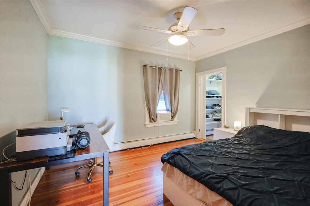 107 Lake Street, Unit B Webster, MA 01570 - Photo 21 of 42 a bedroom with a bed and a chandelier