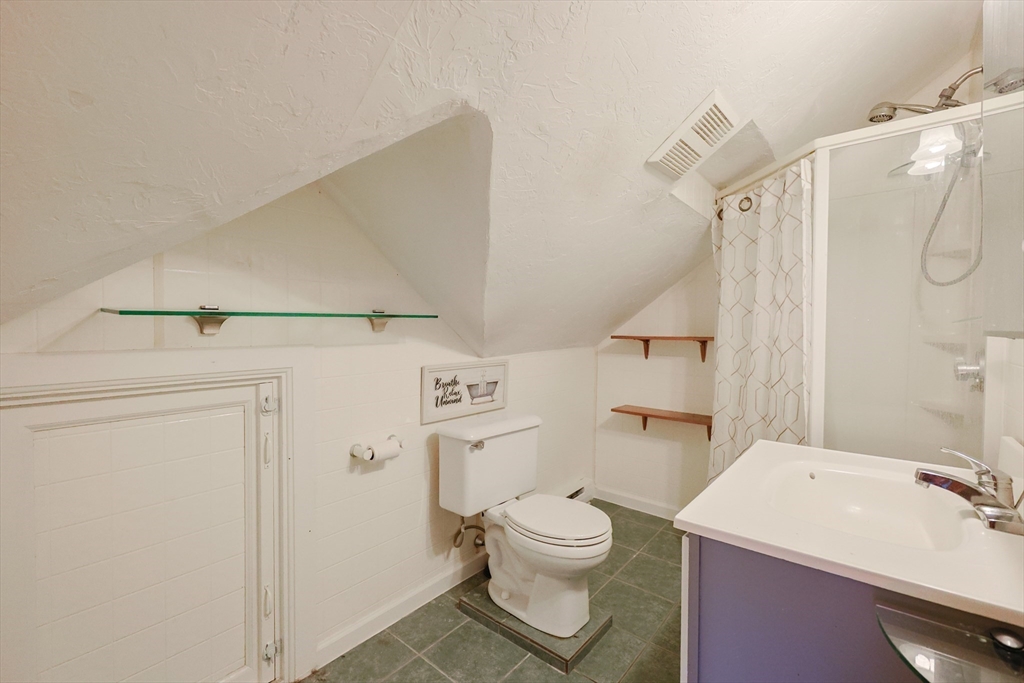 107 Lake Street, Unit B Webster, MA 01570 - Photo 29 of 42 a bathroom with a sink a toilet and shower