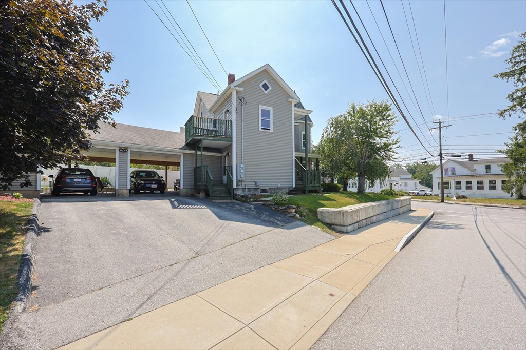 107 Lake Street, Unit B Webster, MA 01570 - Photo 33 of 42 a view of multiple houses with cars parked on the roadside