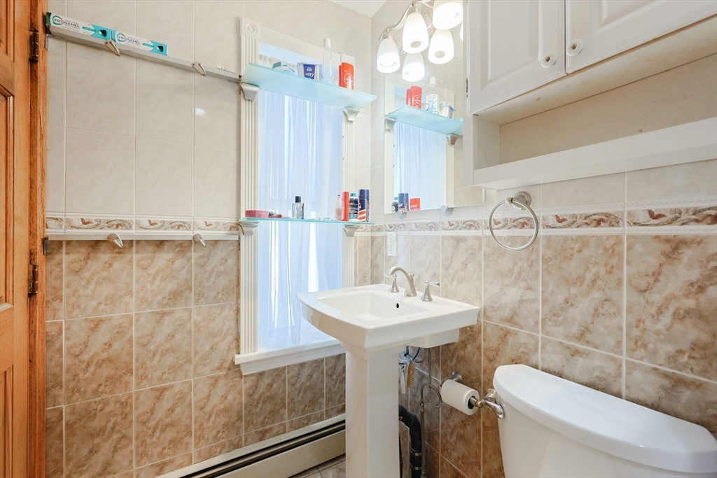 107 Lake Street, Unit B Webster, MA 01570 - Photo 9 of 42 a bathroom with a sink a toilet and shower