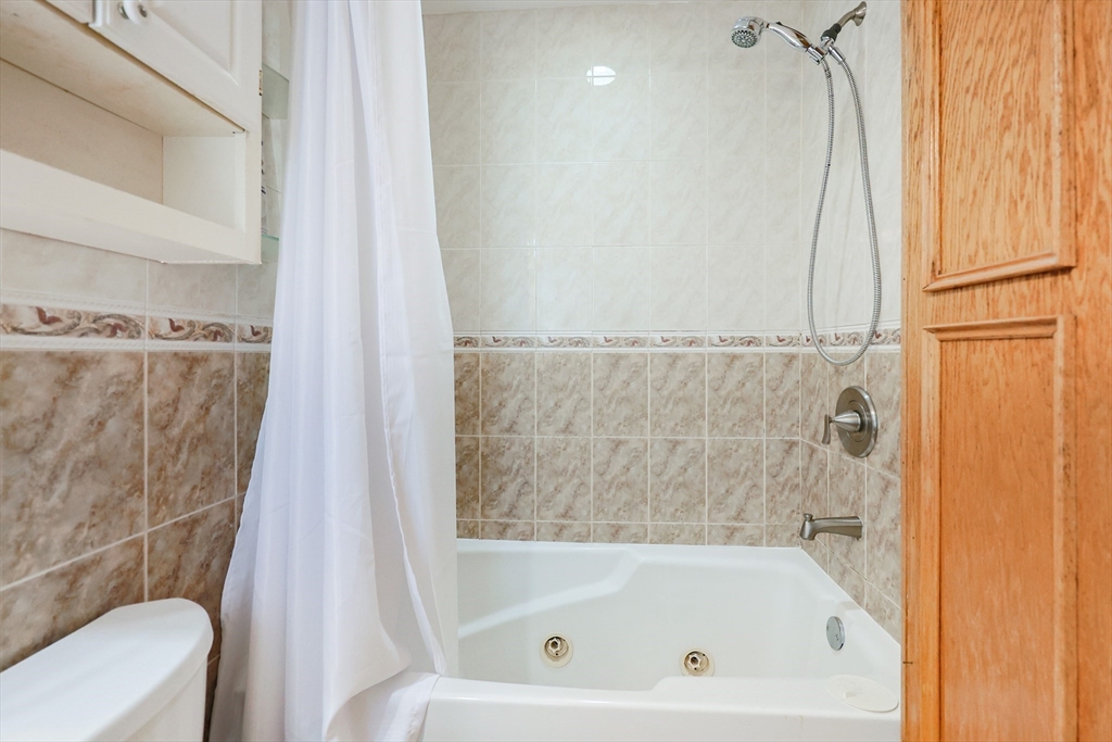 107 Lake Street, Unit B Webster, MA 01570 - Photo 10 of 42 a bathroom with a bathtub and a shower