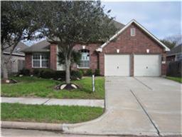 18822 Appletree Ridge Road Houston, TX 77084 - Photo 1 of 27 a front view of a house with a garden