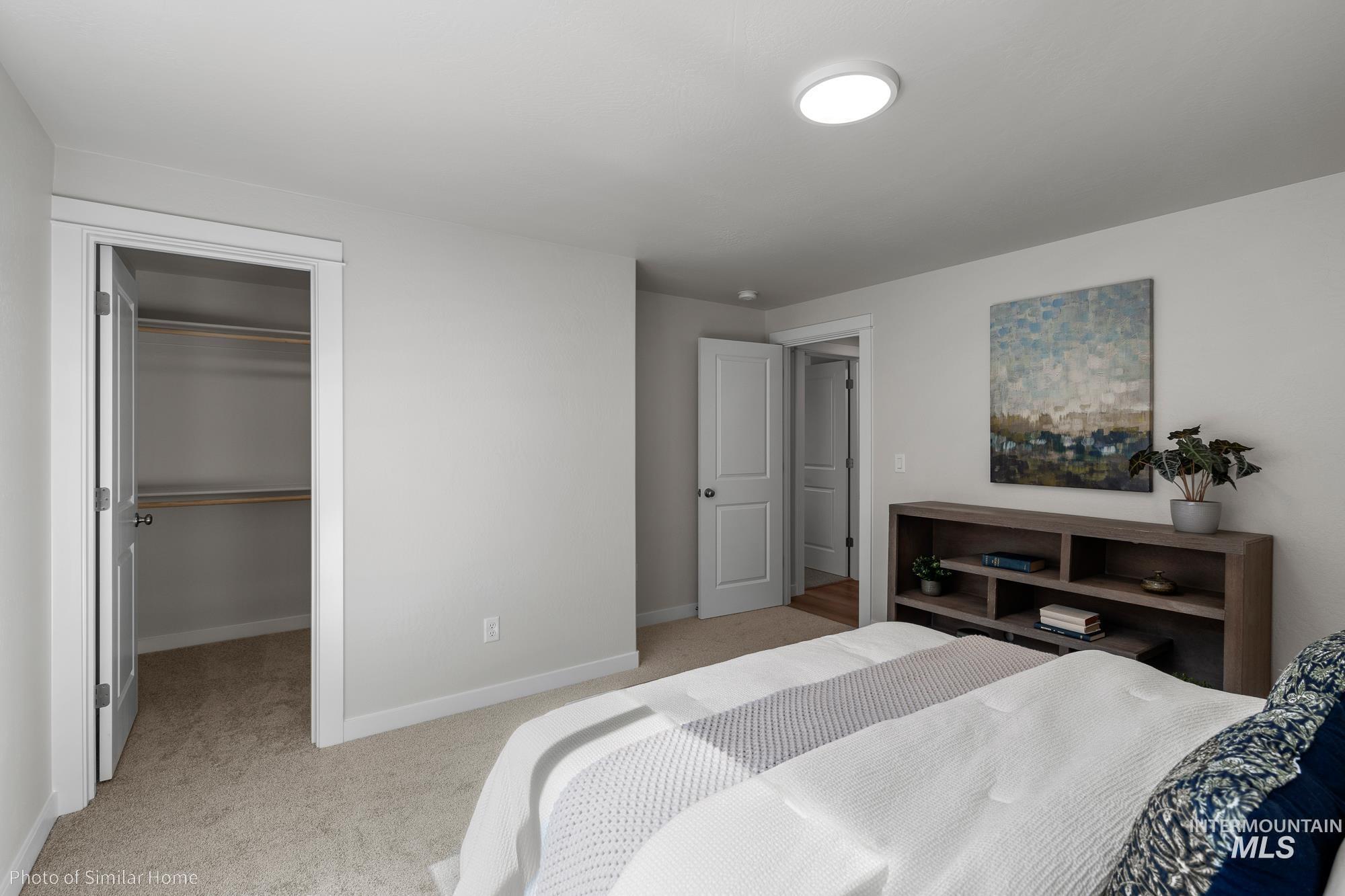 419 Acadia Street Middleton, ID 83644 - Photo 5 of 8 Bedroom with light carpet and a walk in closet