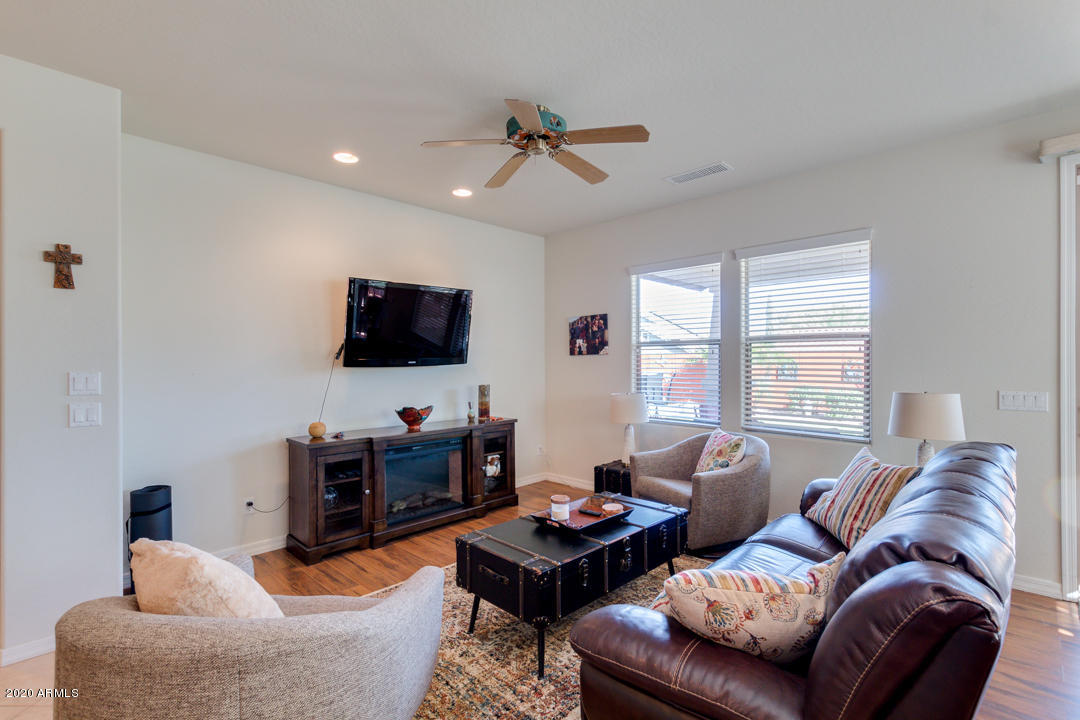 20897 West Ridge Road Buckeye, AZ 85396 - Photo 9 of 91 a living room with furniture a window and a flat screen tv