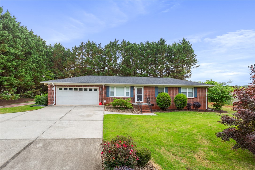 202 Keowee Trail Seneca, SC 29672 - Photo 1 of 35 A well-maintained ranch-style home features a classic brick exterior and an attached garage.