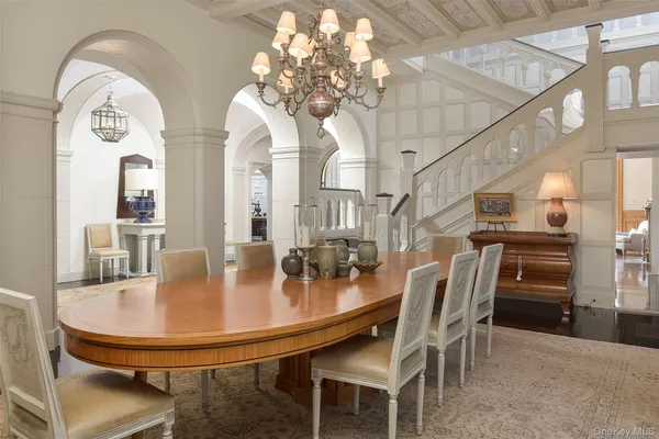 a dining room with furniture and chandelier