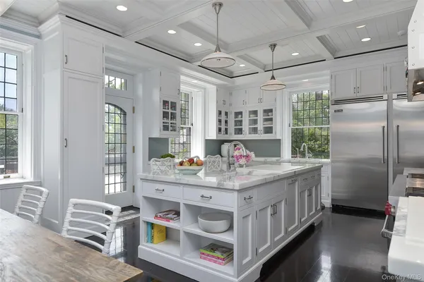 a kitchen with stainless steel appliances granite countertop a lot of counter space cabinets and wooden floor