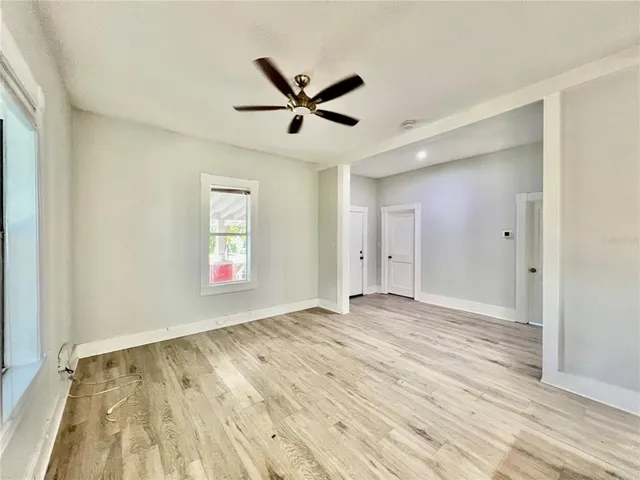wooden floor in an empty room with a window