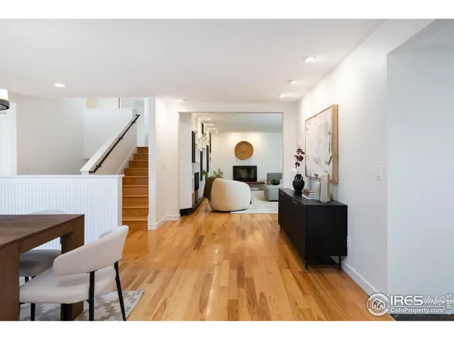 a bedroom with a bed and dresser with mirror