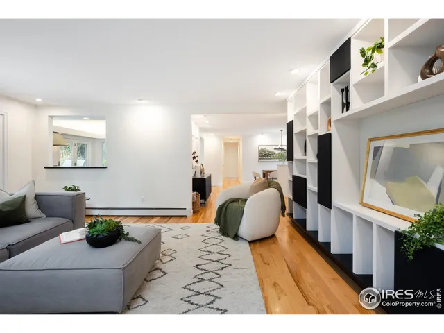 a bedroom with furniture and a large window