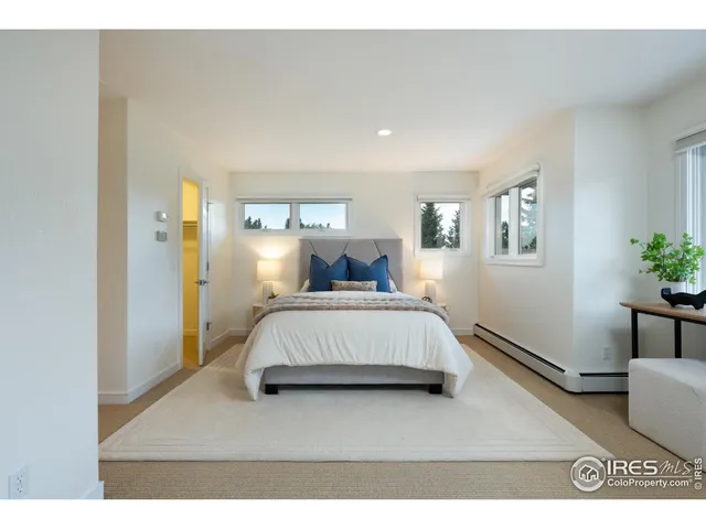 a bedroom with a bed window and a table