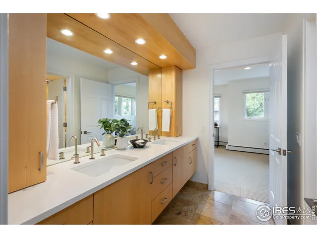 a bathroom with a double vanity sink and a mirror