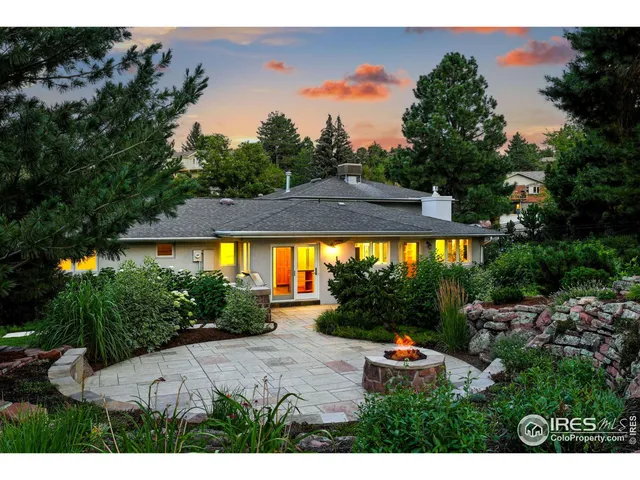 a view of a patio with a table and chairs under an umbrella