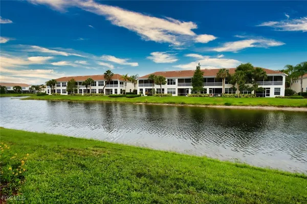 a view of a lake with houses in the background