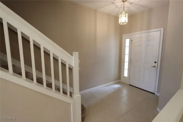 a view of staircase with railing and white walls