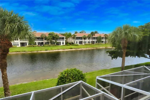 a view of a lake with a house in the background