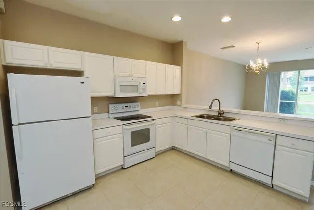 a kitchen with cabinets and white appliances