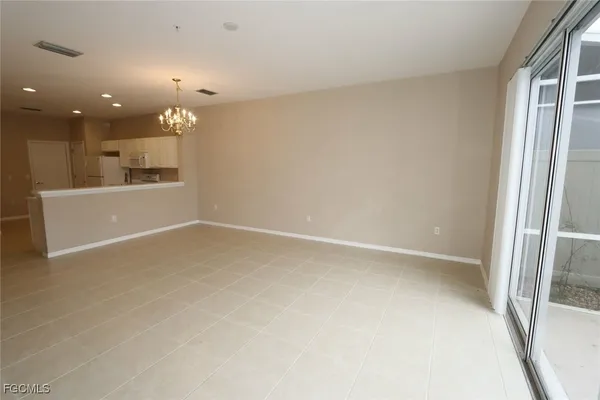an empty room with a empty space and windows