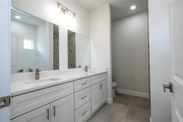 a view of kitchen with kitchen island stainless steel appliances refrigerator stove microwave and cabinets