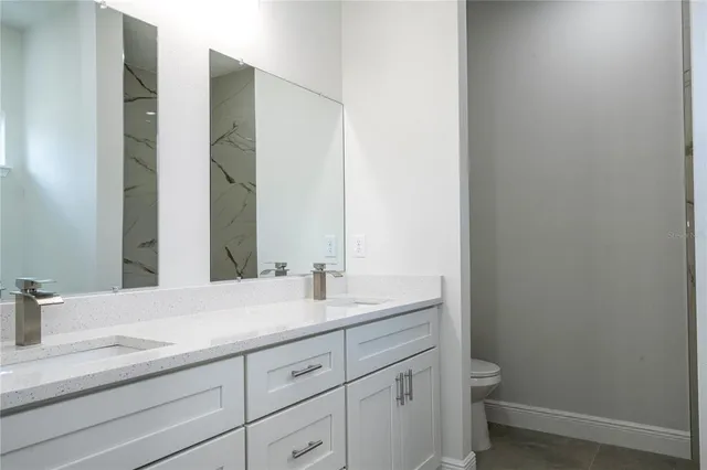 a kitchen with stainless steel appliances granite countertop a refrigerator a stove a sink and a microwave