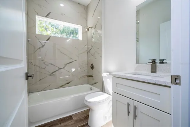 an aerial view of residential houses with outdoor space and parking