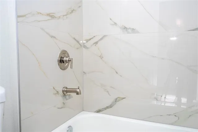 a view of a room with wooden floor and a bathroom sink