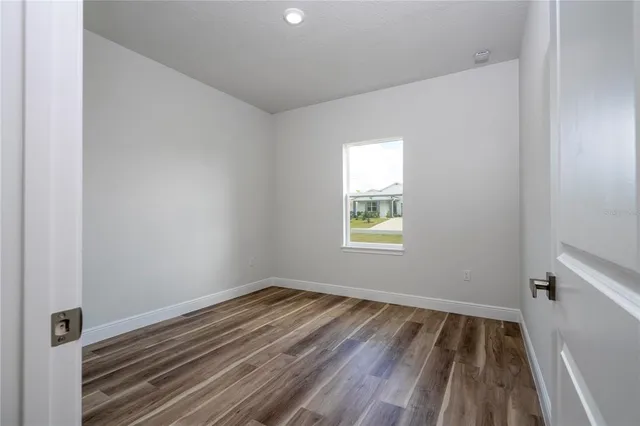 a view of room with window and hardwood floor